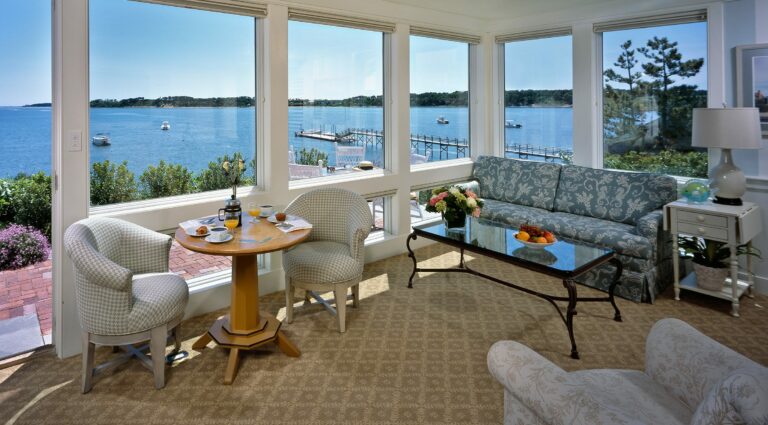 Cape Cod hotel suite with many windows overlooking the ocean.
