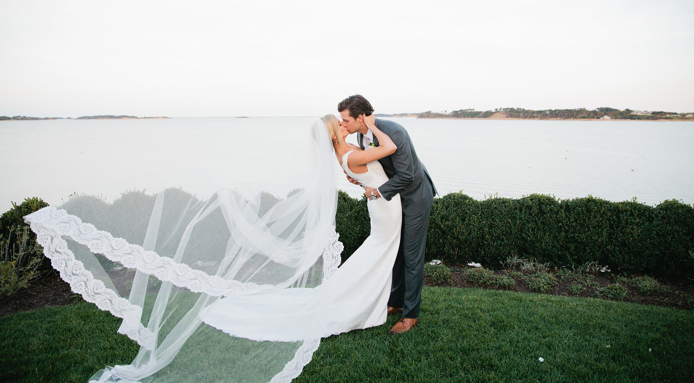 Wedding couple kiss on Cape Cod waterfront