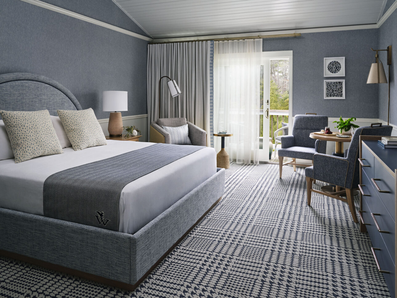 Elegant king guest room with coastal hues and private patio.