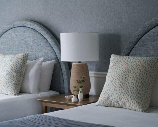 Chic coastal double beds with soft linens and bespoke decor.