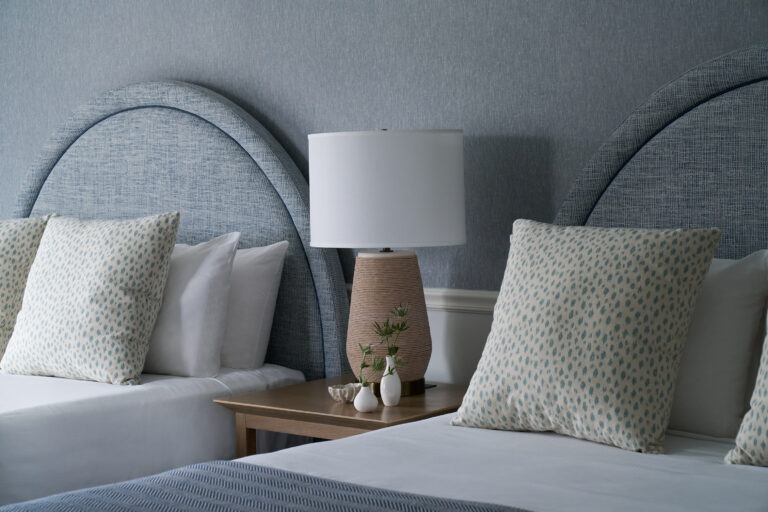 Chic coastal double beds with soft linens and bespoke decor.