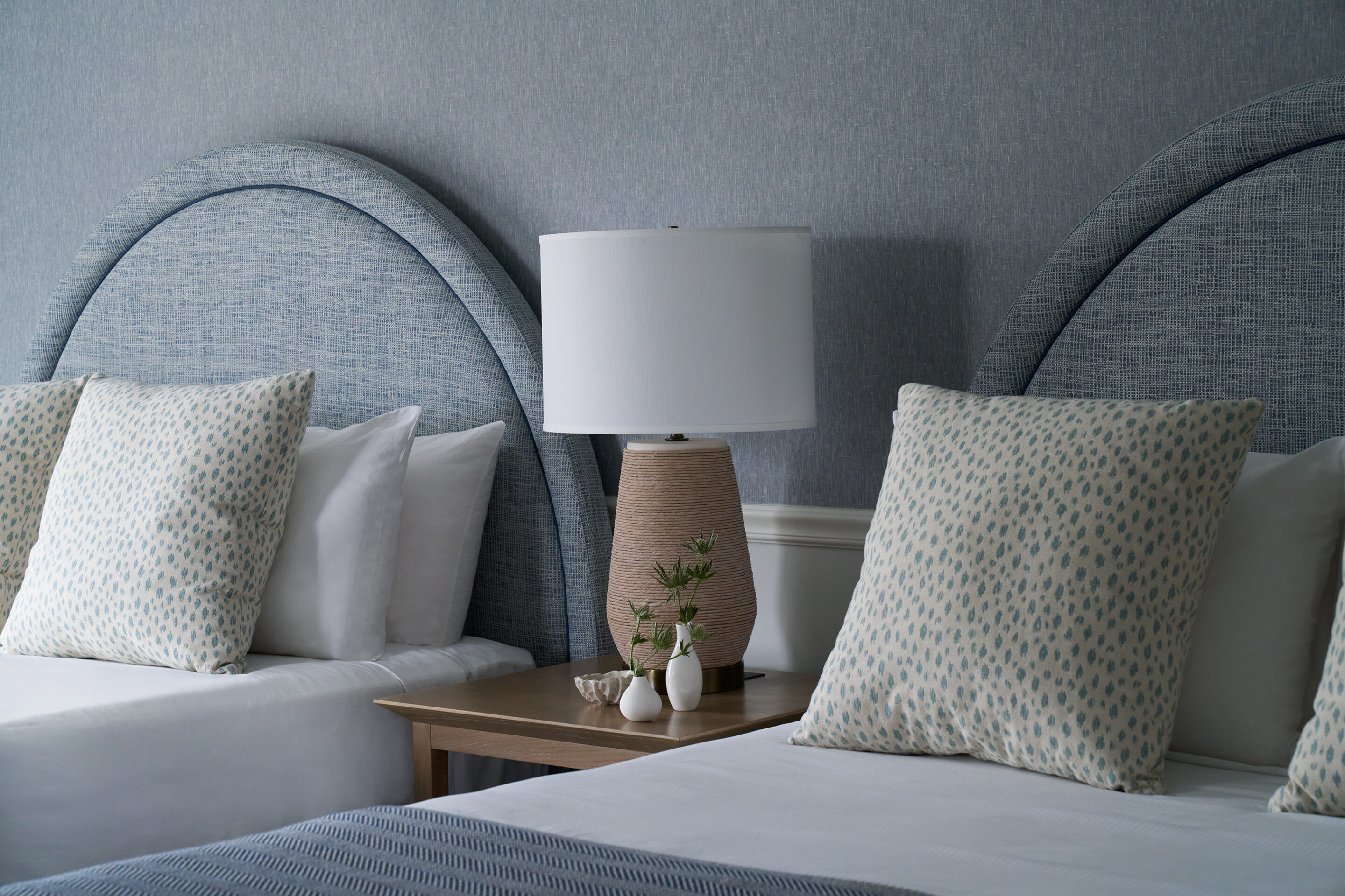 Chic coastal double beds with soft linens and bespoke decor.