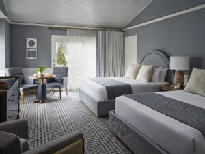 Spacious guest room with ocean-inspired tones and 2 queen beds.