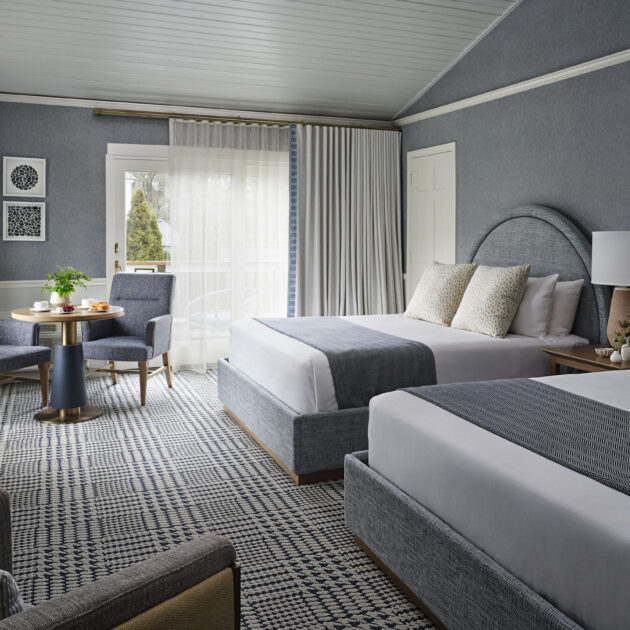 Spacious guest room with ocean-inspired tones and 2 queen beds.