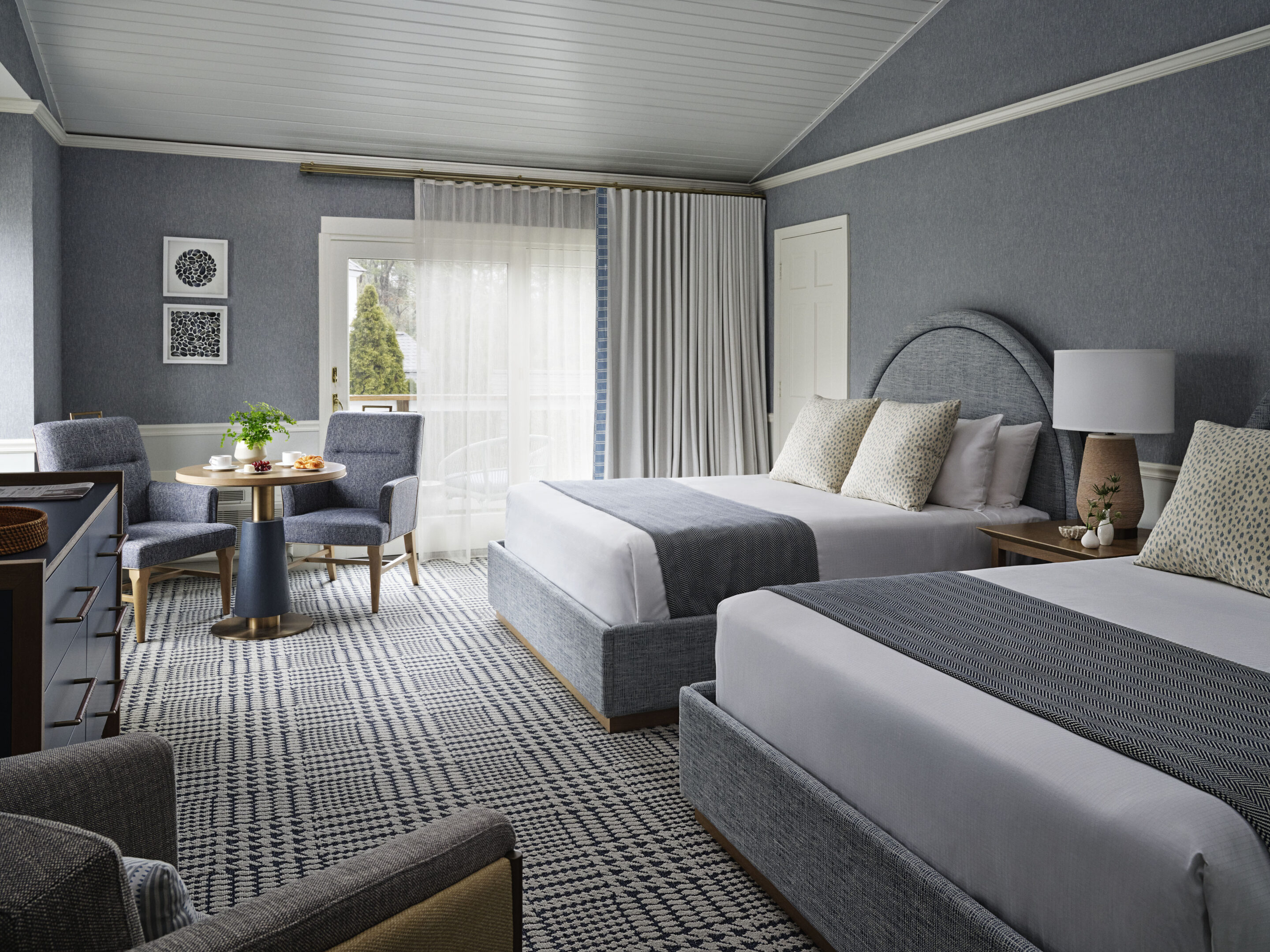 Spacious guest room with ocean-inspired tones and 2 queen beds.