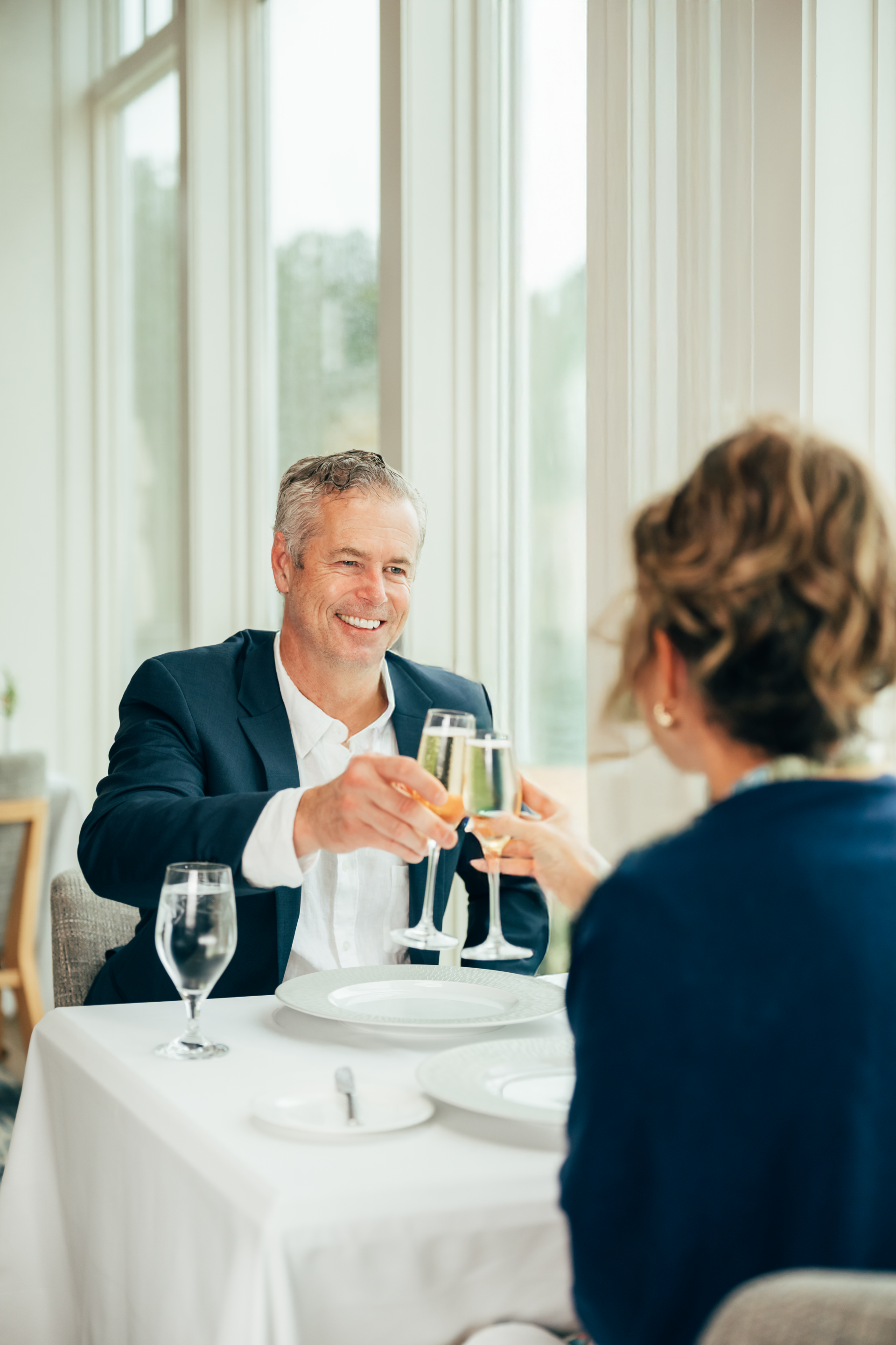 Couple in navy jackets drinking champagne