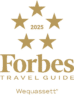 Gold Forbes Travel Guide 2025 logo with five stars above the text "Forbes Travel Guide" and "Wequassett Resort" written below, reflecting the luxury of this renowned resort and golf club.