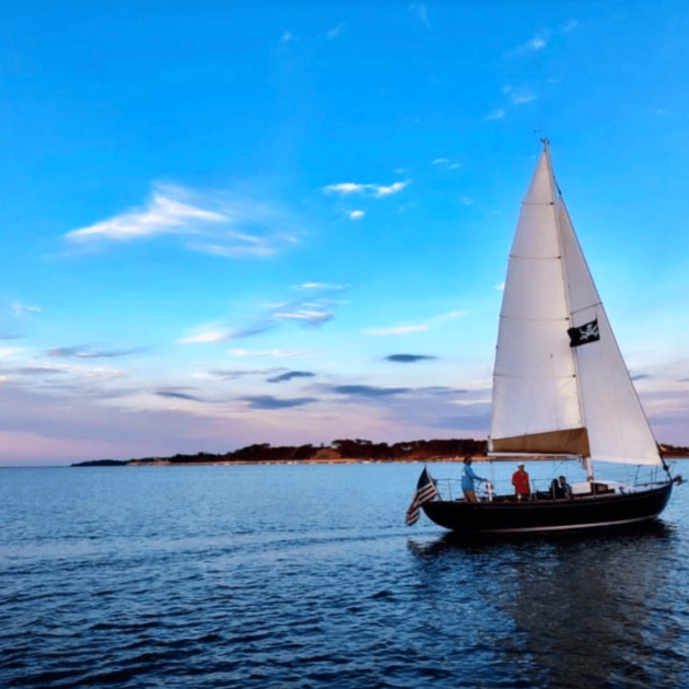 Sail boat in Cape Cod with the sunset in the background