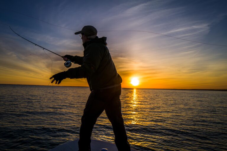 man fishing at sunset.