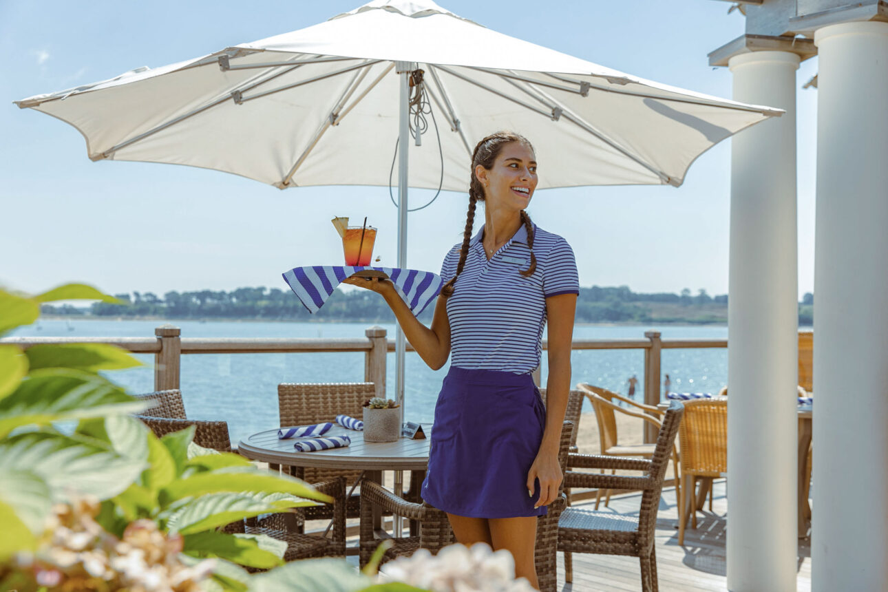 Waitress carrying drinks.