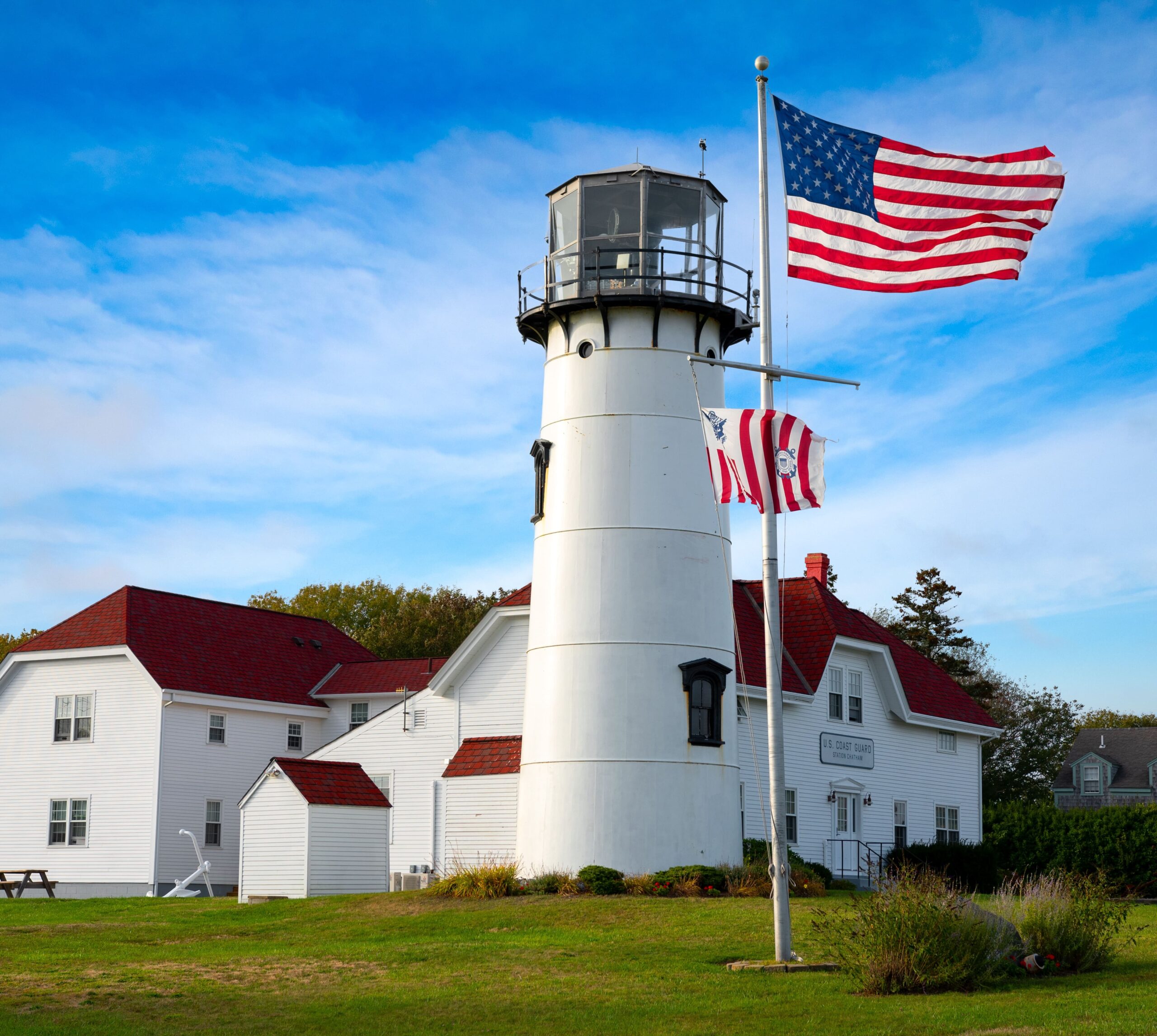 lighthouse with flag in front