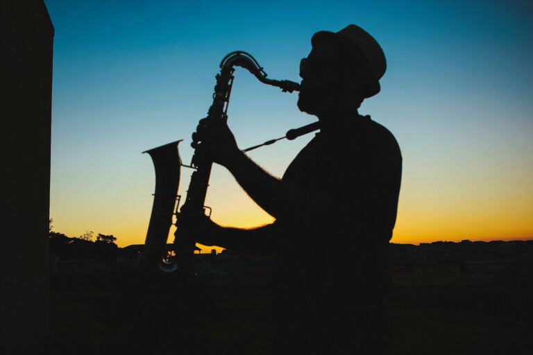 jazz musician playing the saxophone at sunset