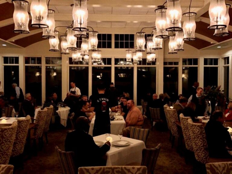 twenty eight Atlantic fine dining restaurant with many people sitting at tables and eating food.